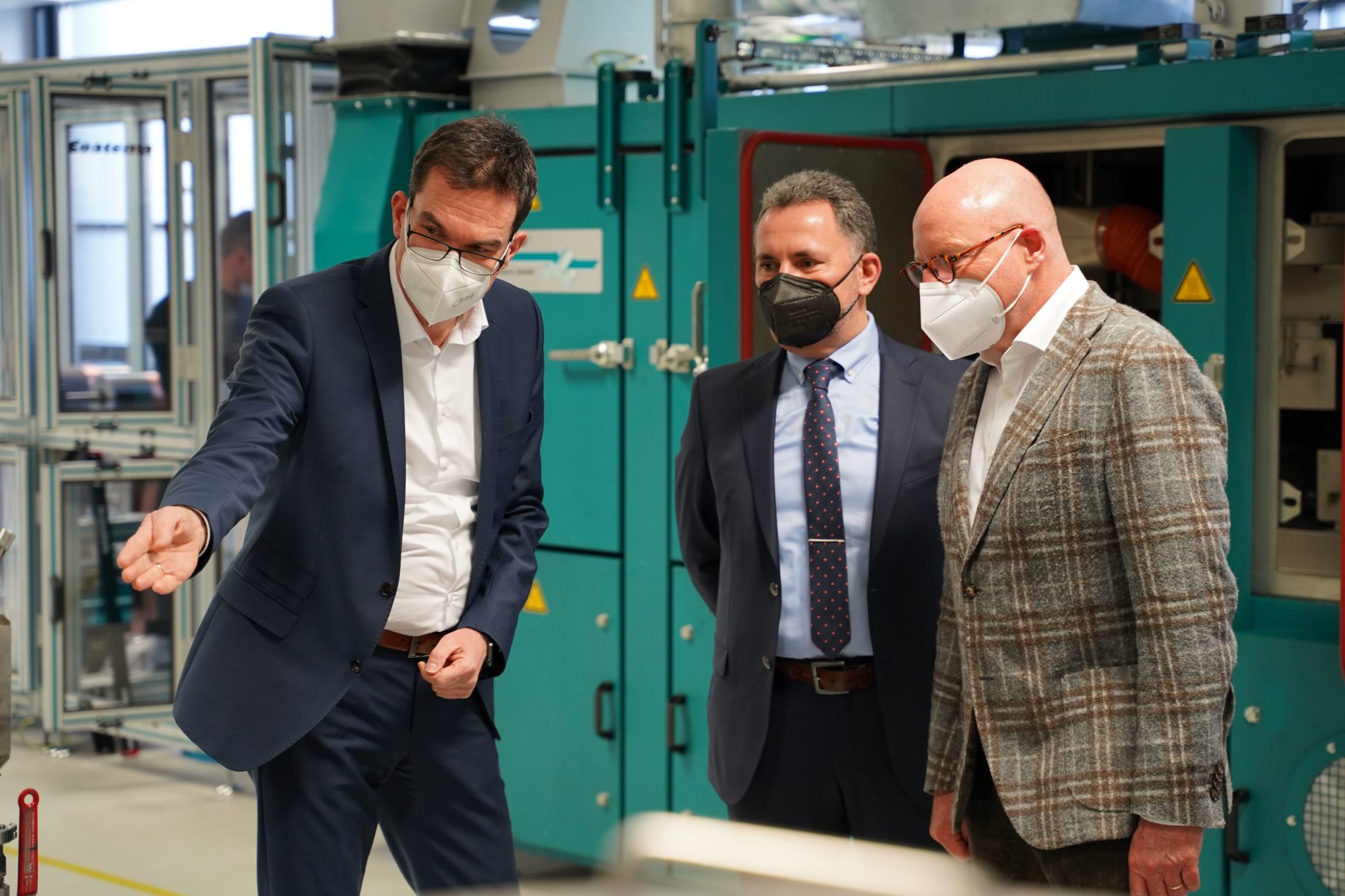Oberbürgermeister Markus Lewe (r.) lässt sich von Werksleiter Stefan Löher (l.) und Prof. Jens Tübke, geschäftsführender Leiter der Fraunhofer Forschungsfertigung Batteriezelle, den „FFB Workspace“ zeigen.